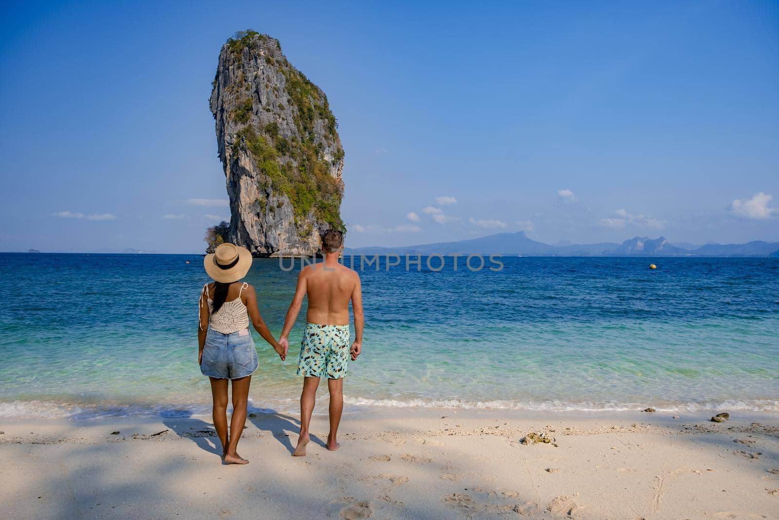 Koh Poda Island Thailand, couple mid age Asian woman and European man on the beach, Koh Poda Thailand, beautiful tropical beach of Koh Poda, Poda Island in Krabi province of Thailand South East Asian