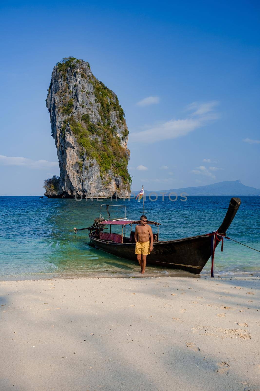 Koh Poda Island Thailand, couple mid age Asian woman and European man on the beach, Koh Poda Thailand, beautiful tropical beach of Koh Poda, Poda Island in Krabi province of Thailand South East Asian