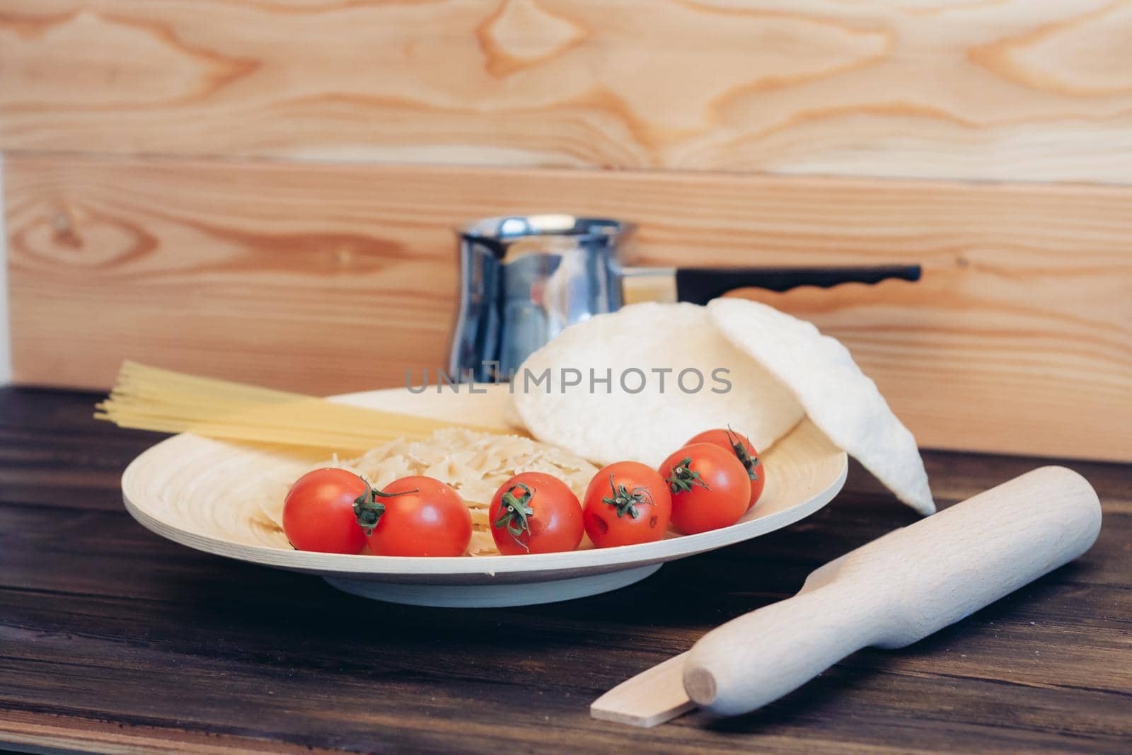 cherry tomatoes pasta kitchenware wooden table italian cuisine. High quality photo