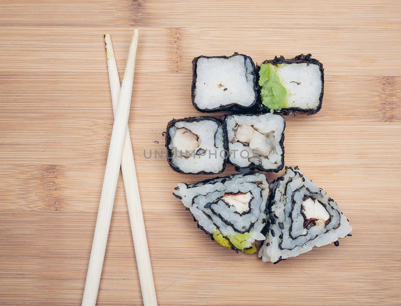 sushi rolls chopsticks food ration delicacy wood board japanese cuisine. High quality photo