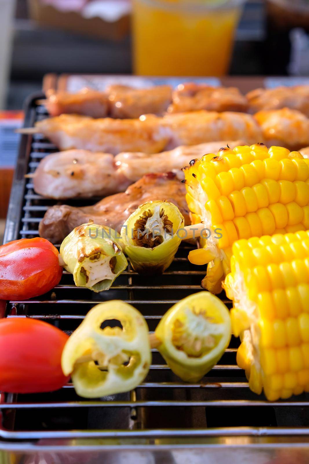 Closeup image of Grilled vegetable and chicken skewers on a hot barbecue