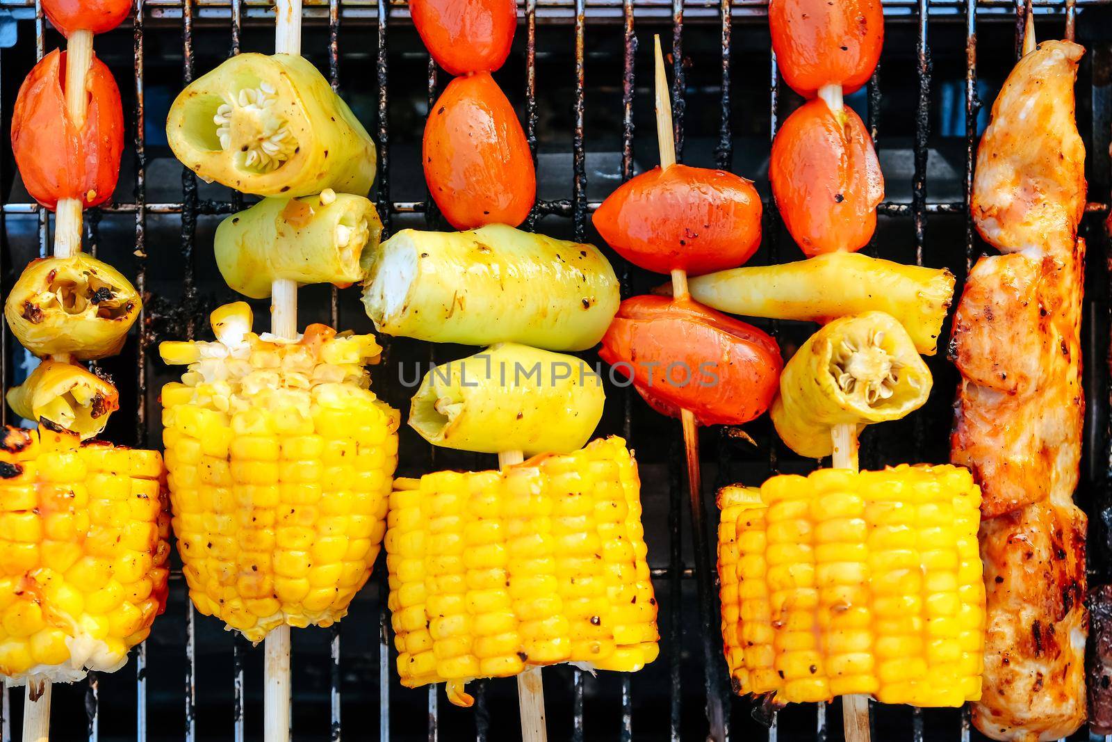 Closeup image of Grilled vegetable and chicken skewers on a hot barbecue