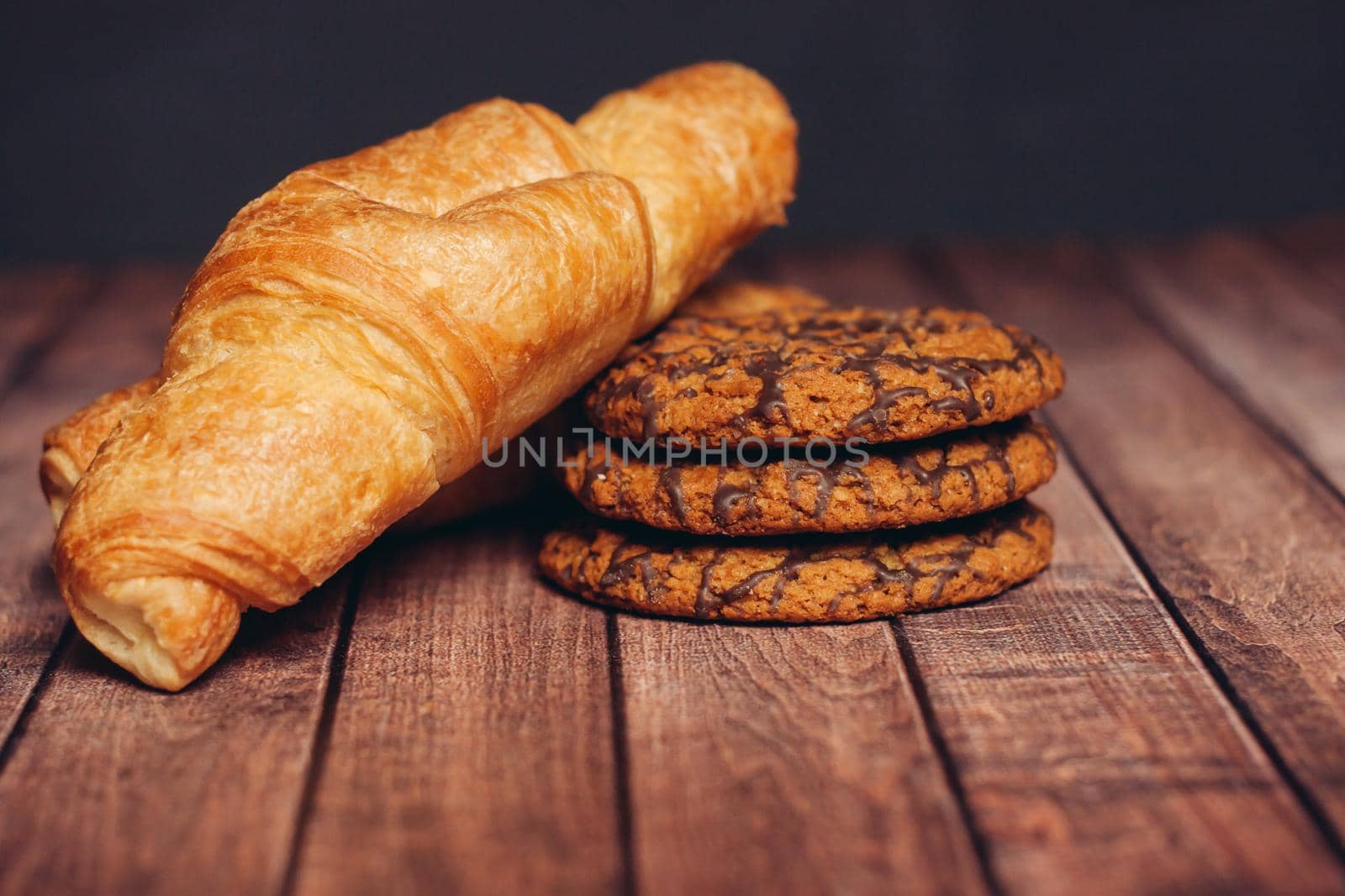 sweets for tea croissants cookies on a wooden table snack. High quality photo