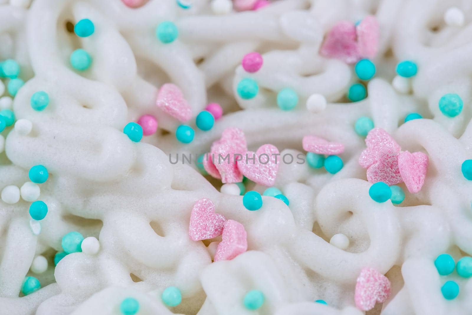 The texture of icing on a cake with pastry sprinkles, macro photography.