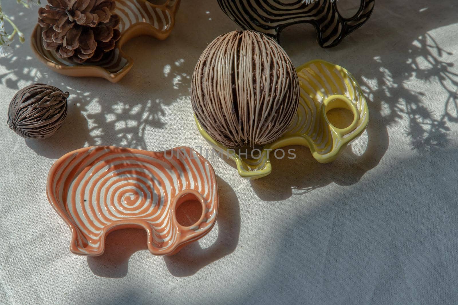 Set of Elephants shaped ceramics cup and Dried cerbera oddloam's seed to Decorate the house beautifully. Elephants shaped cup for dipping sauce, Copy space, Selective focus.