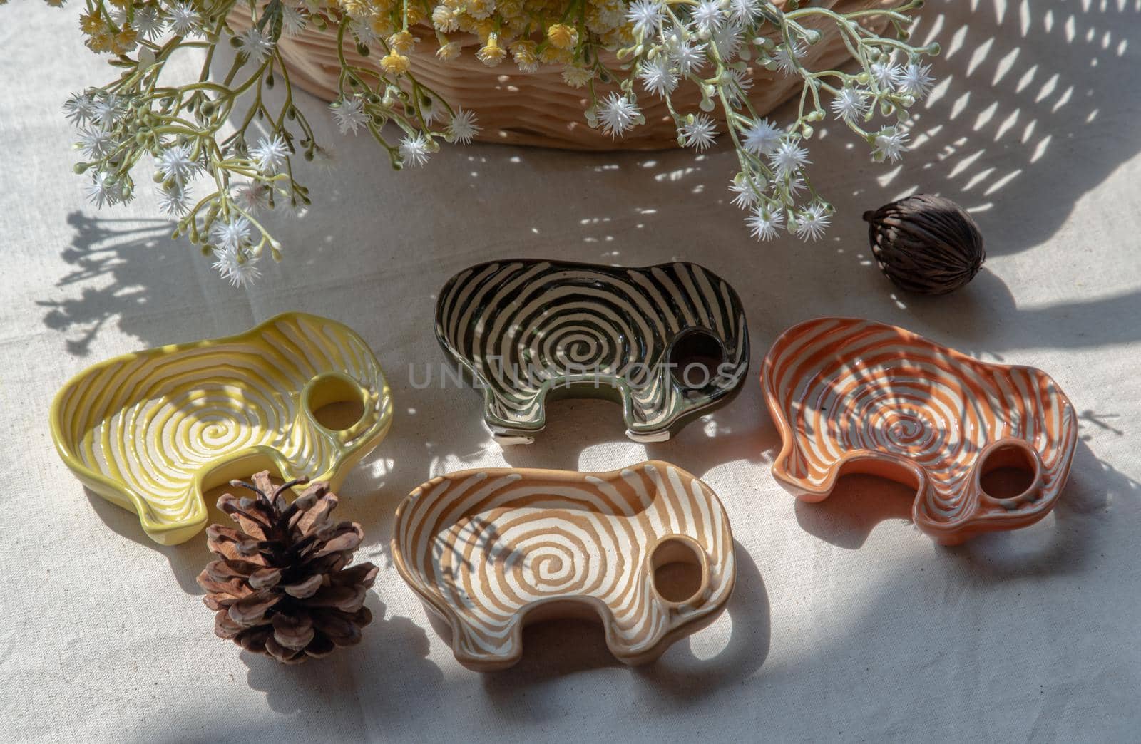 Set of Elephants shaped ceramics cup and Pine cone to Decorate the house beautifully. Elephants shaped cup for dipping sauce, Selective focus.