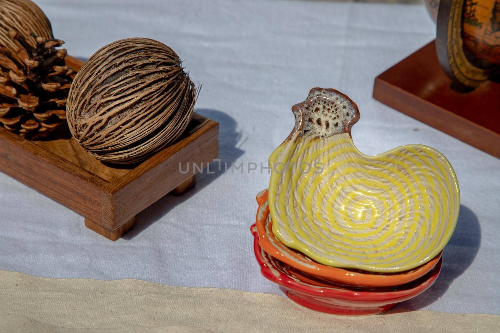 Set of Chickens shaped ceramics cup and Dried cerbera oddloam's seed to Decorate the house beautifully. Chickens shaped cup for dipping sauce, Selective focus.