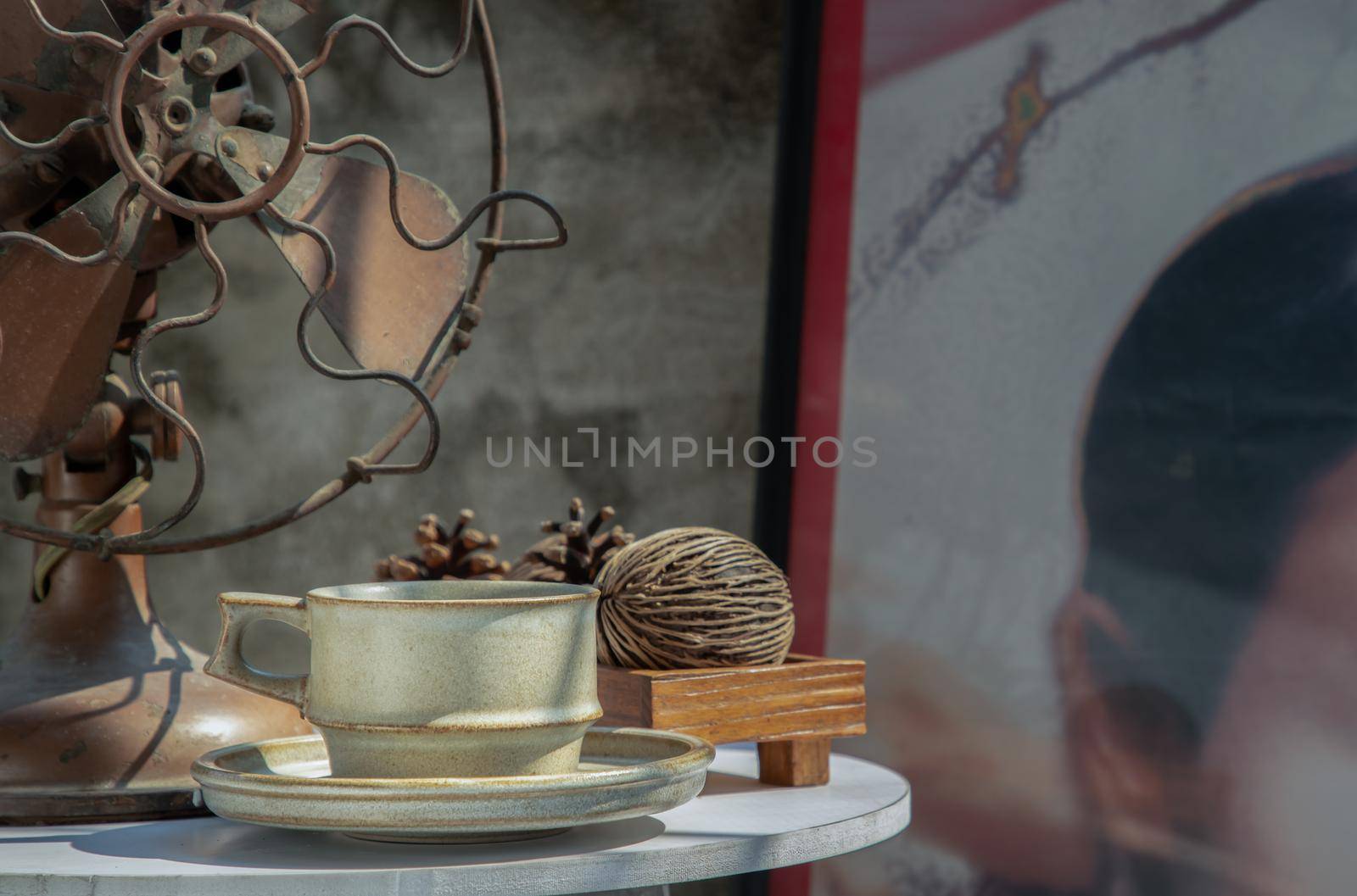 Ceramic mug handmade in Chinese retro style room with old ruins cement wall. Selective focus.