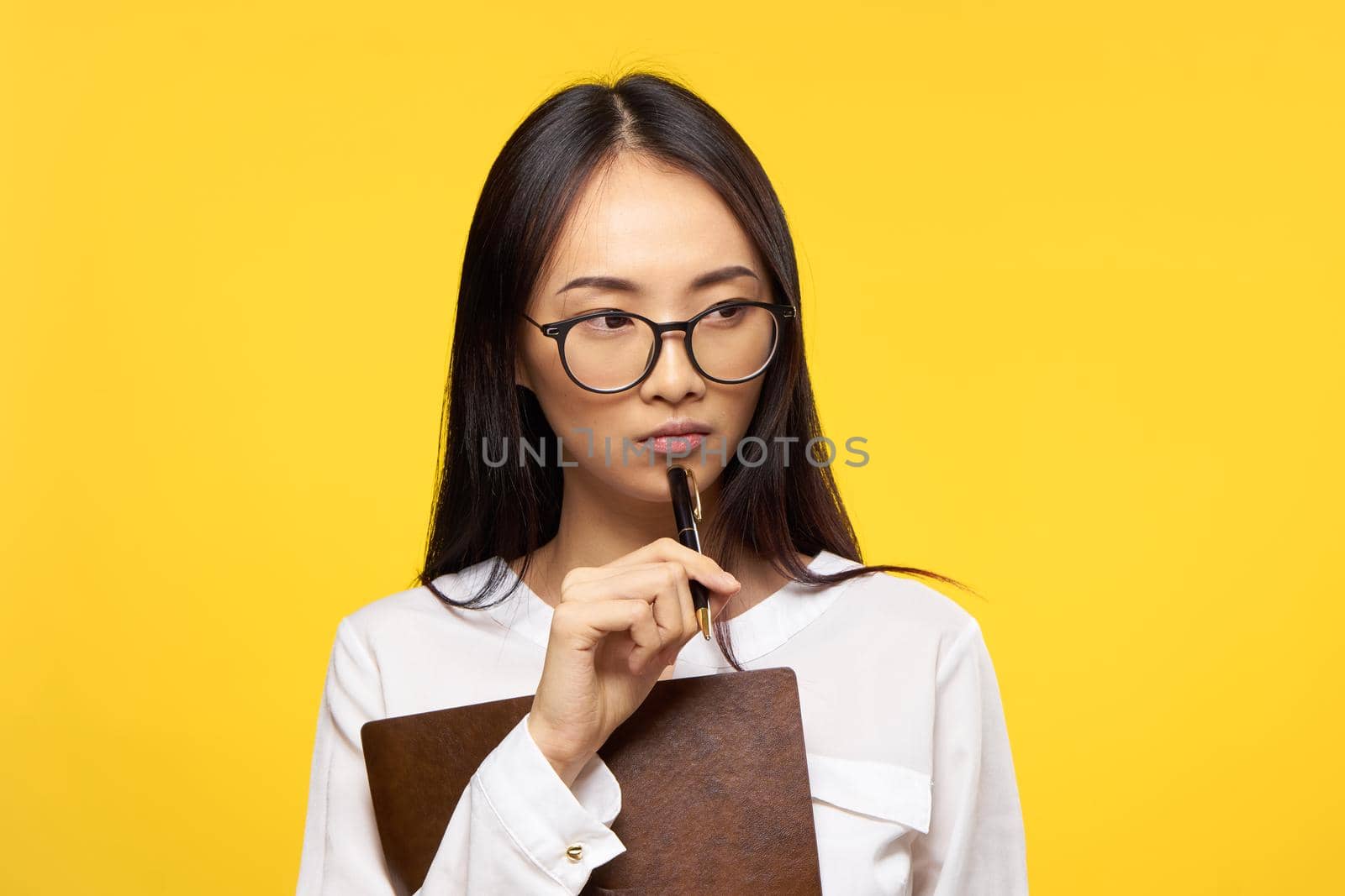 woman asian appearance secretary work office yellow background. High quality photo