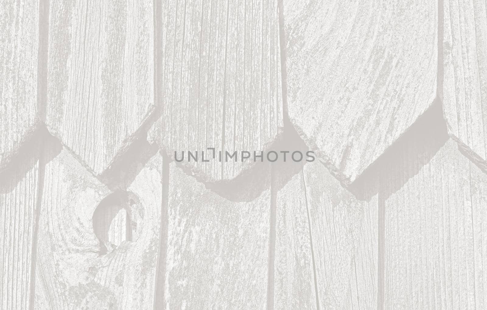 Fragment of the wall of an old rural house made of wooden planks. Background texture of old wooden wall. Image in light gray tonality