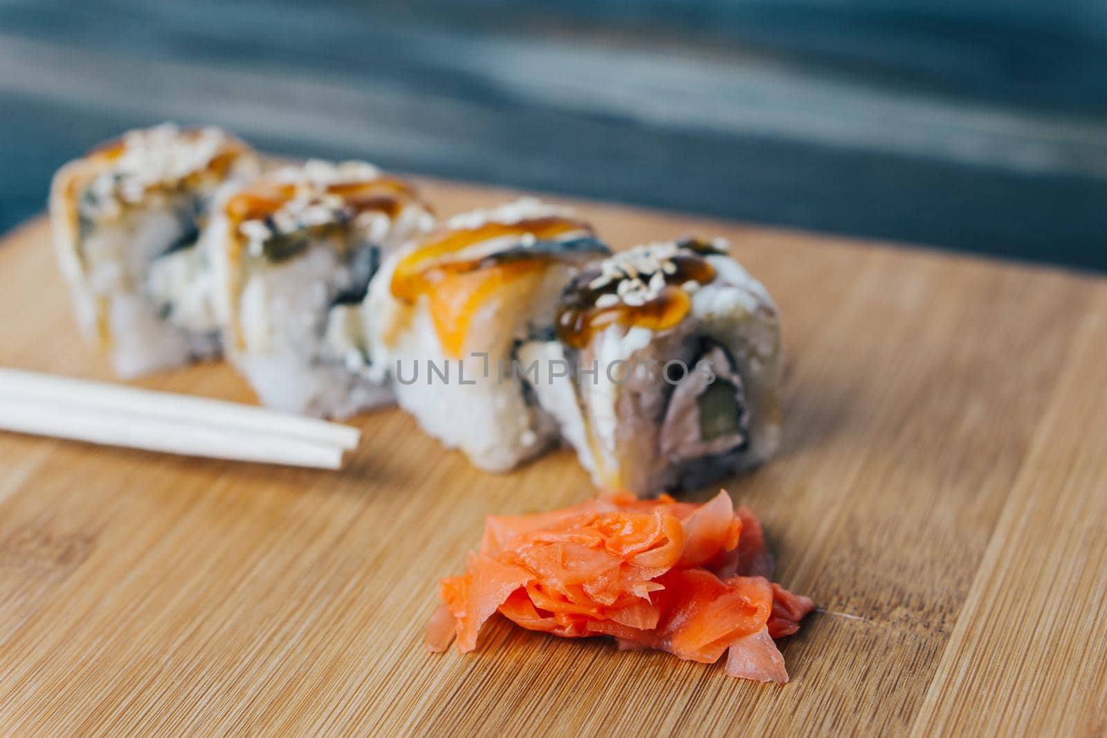 red ginger sushi chopsticks wooden board meal delicacy. High quality photo