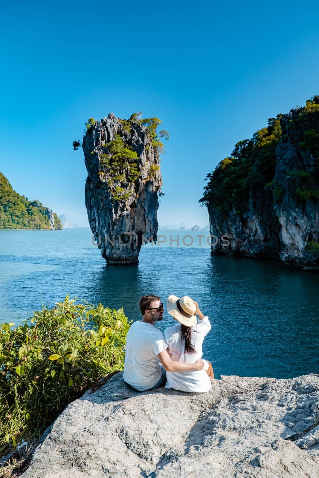 James Bond island near Phuket in Thailand. Famous landmark and famous travel destination, couple men and woman mid age visititng James Bond island in Krabi Thailand by fokkebok