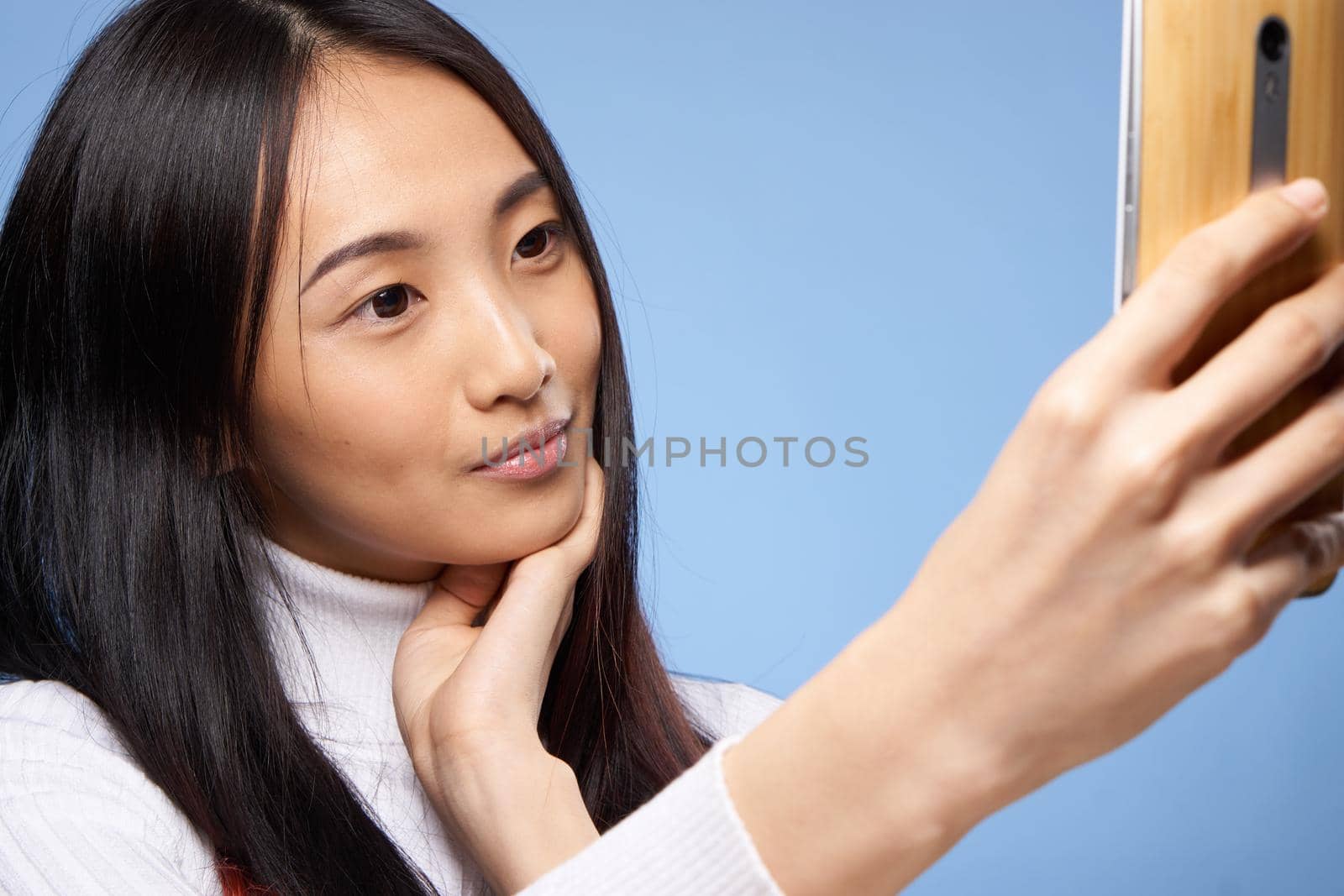 pretty brunette with a phone in her hands the charm of internet communication technology close-up. High quality photo