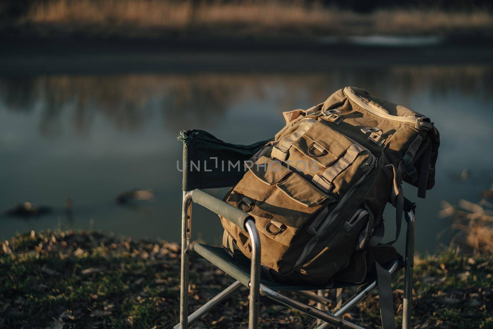 backpacker bag folding chair nature lake travel outdoor. High quality photo