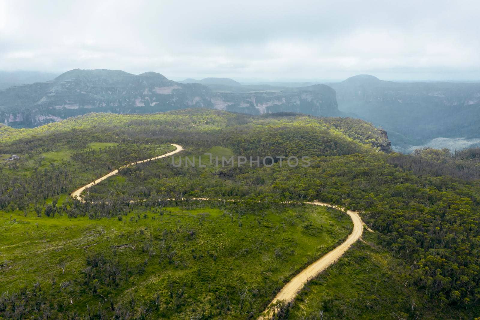 Aerial view of a dirt track running through the Grose Valley near Blackheath in The Blue Mountains in regional New South Wales in Australia