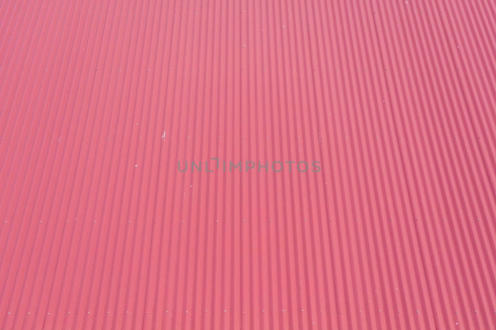 Aerial view of burgundy coloured corrugated iron roof panels