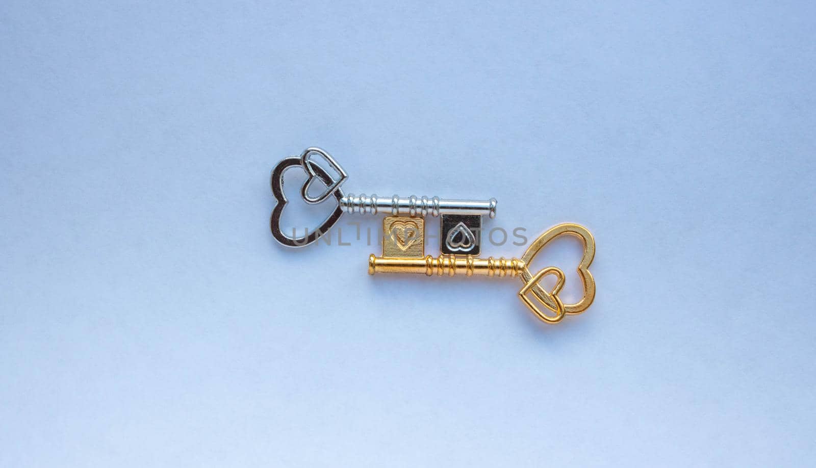 Gold and silver keys isolated on a white background.
