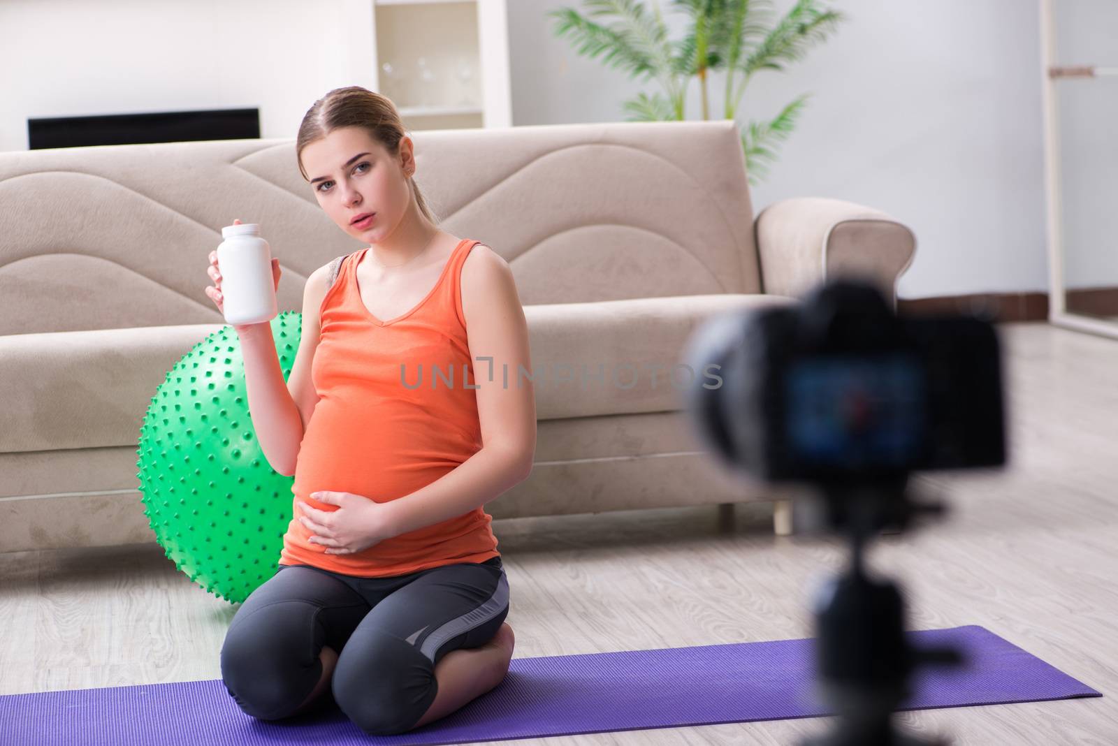 Pregnant woman recording video for blog and vlog