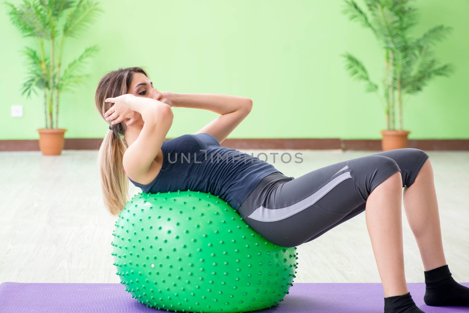 Woman doing exercises with swiss ball by Elnur