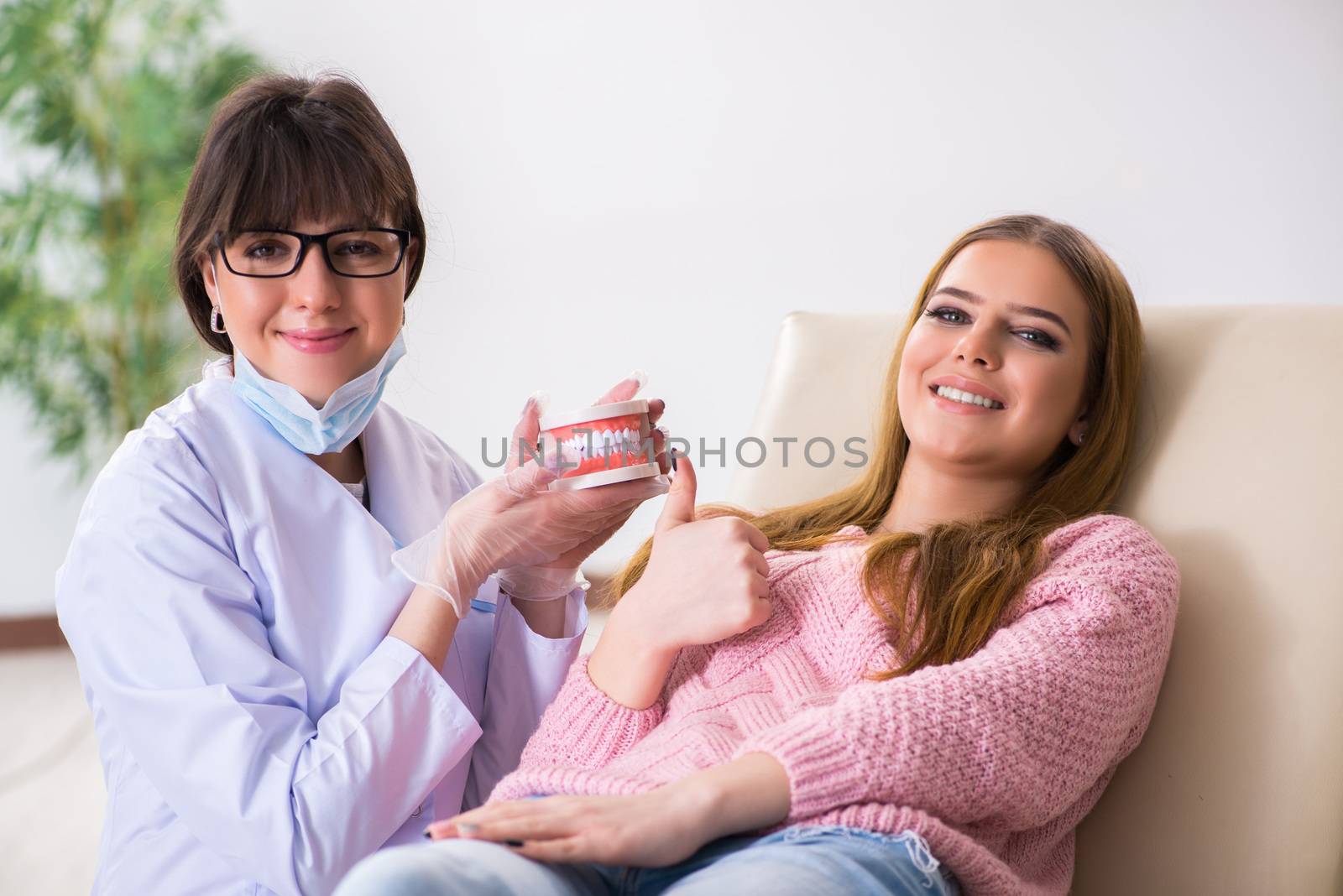 Woman patient visiting dentist for regular check-up by Elnur