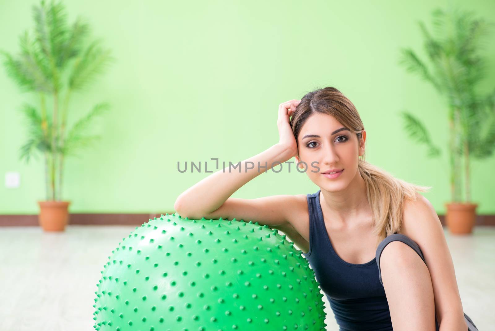 Woman doing exercises with swiss ball by Elnur