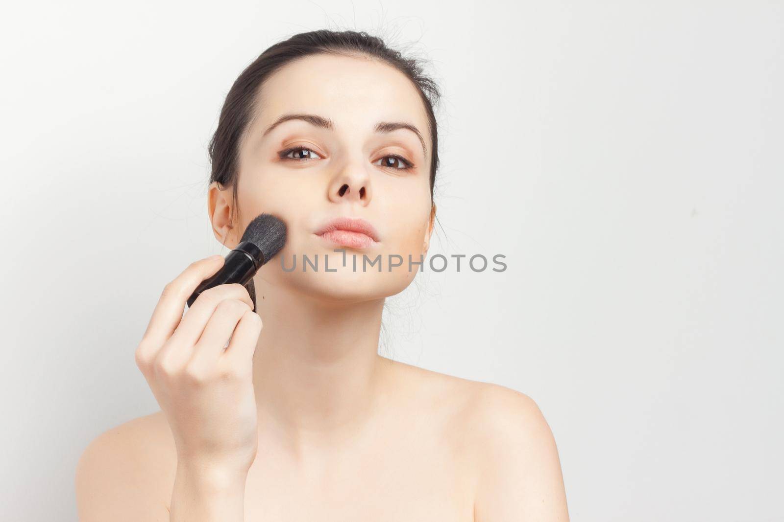 brunette bare shoulders face mask brushing cropped view skincare. High quality photo