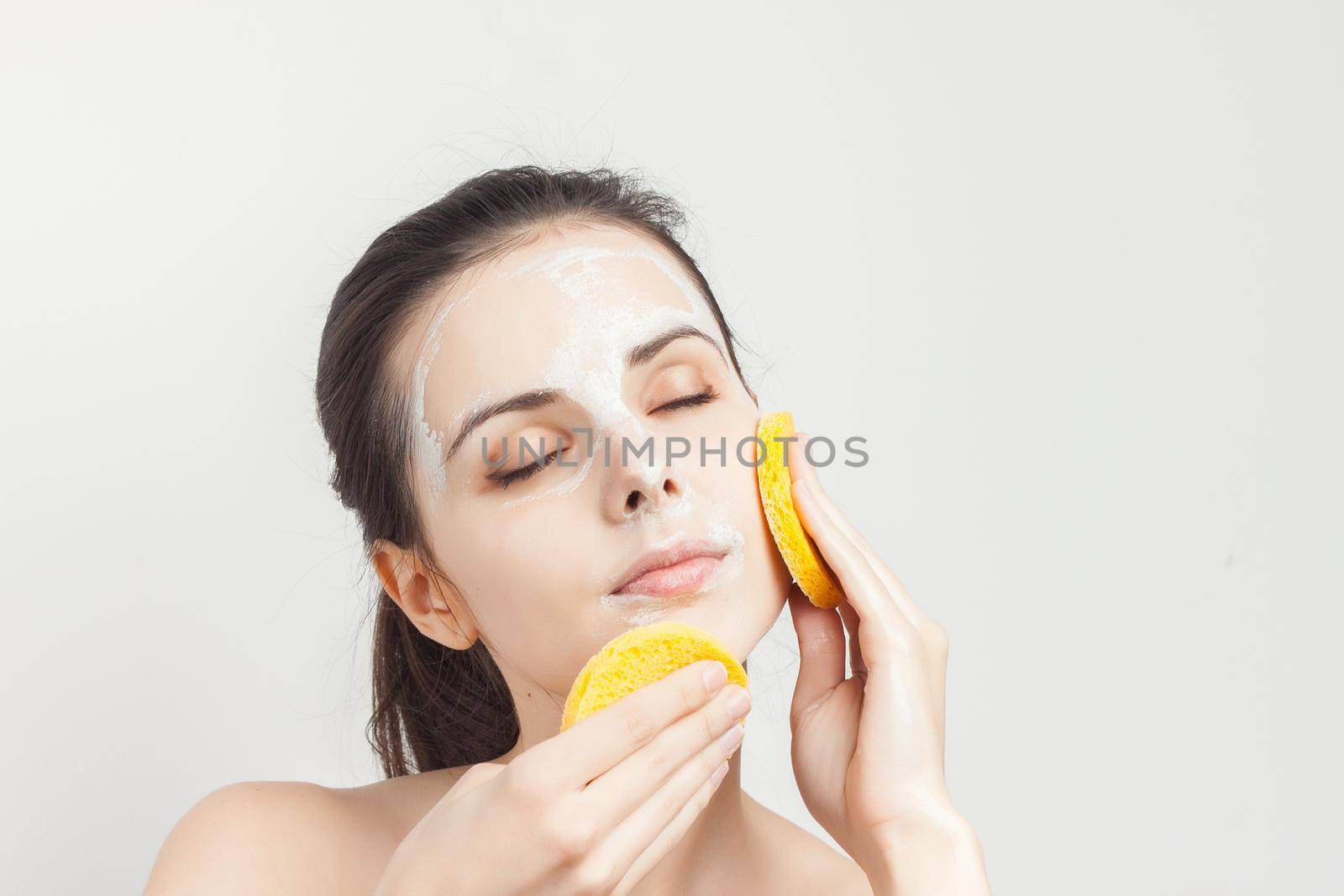 pretty woman with face cream mask skin care naked shoulders. High quality photo