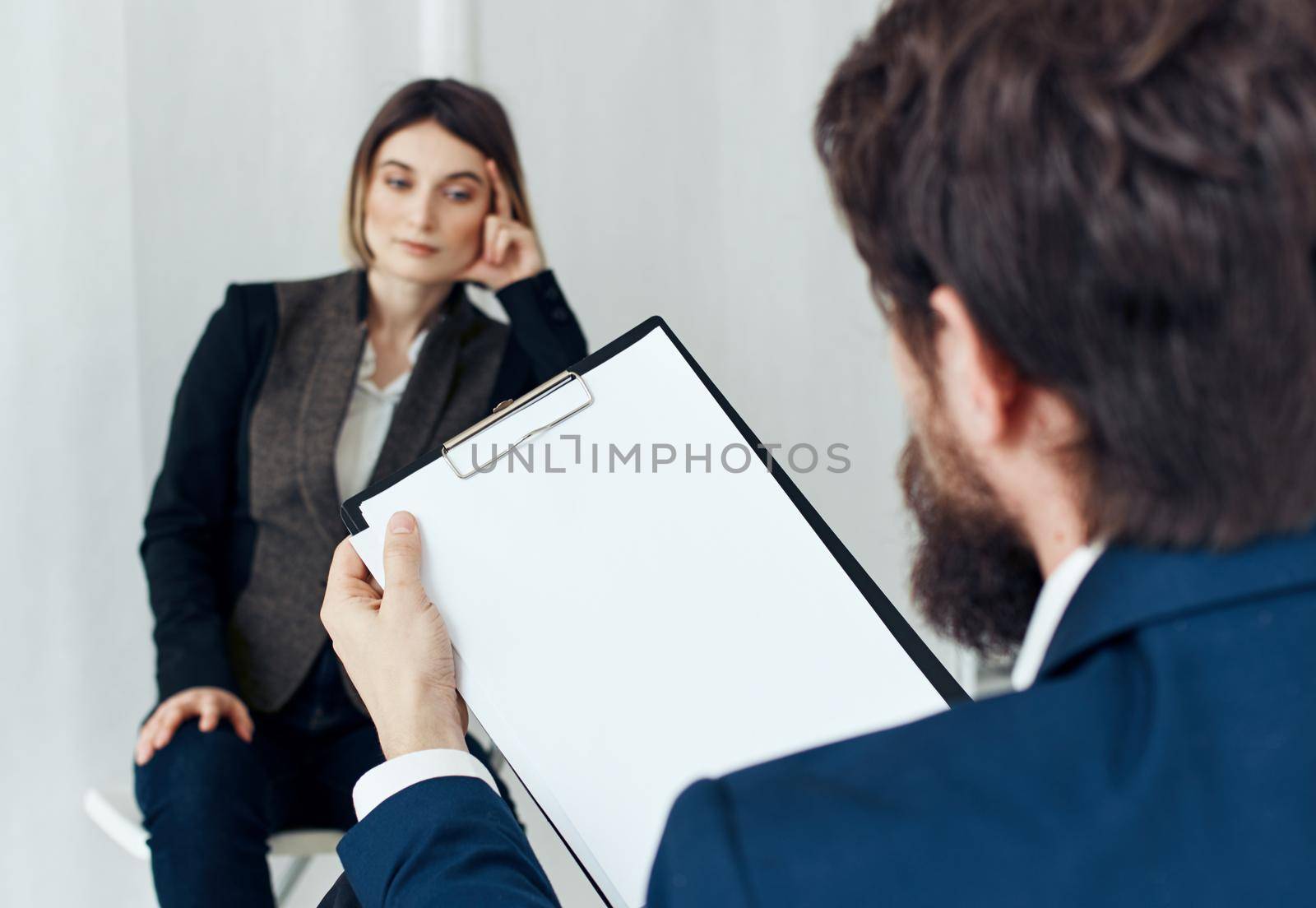 Woman for job interview and man with documents in the foreground. High quality photo