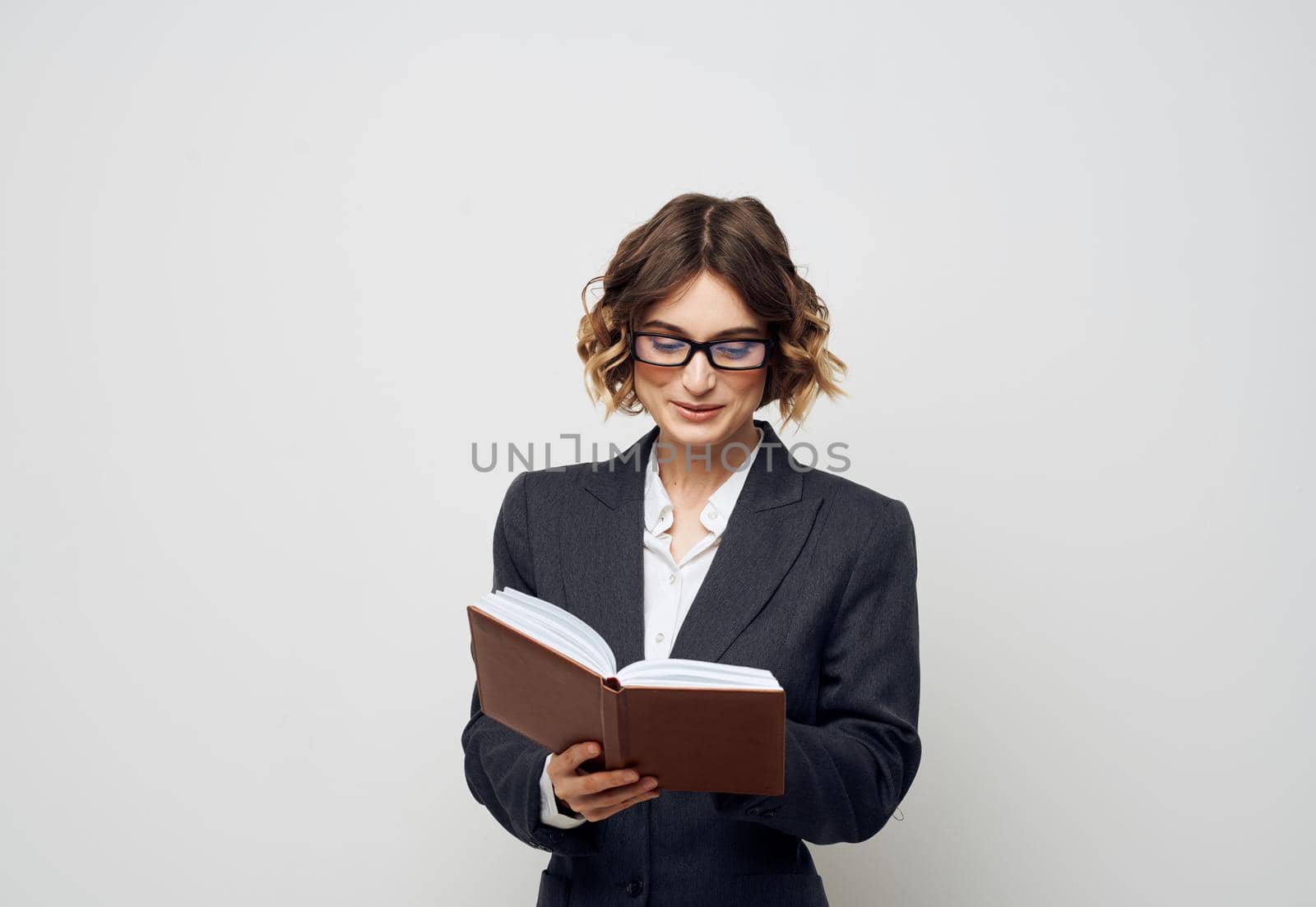 Business woman books documents model suit hairstyle glasses. High quality photo