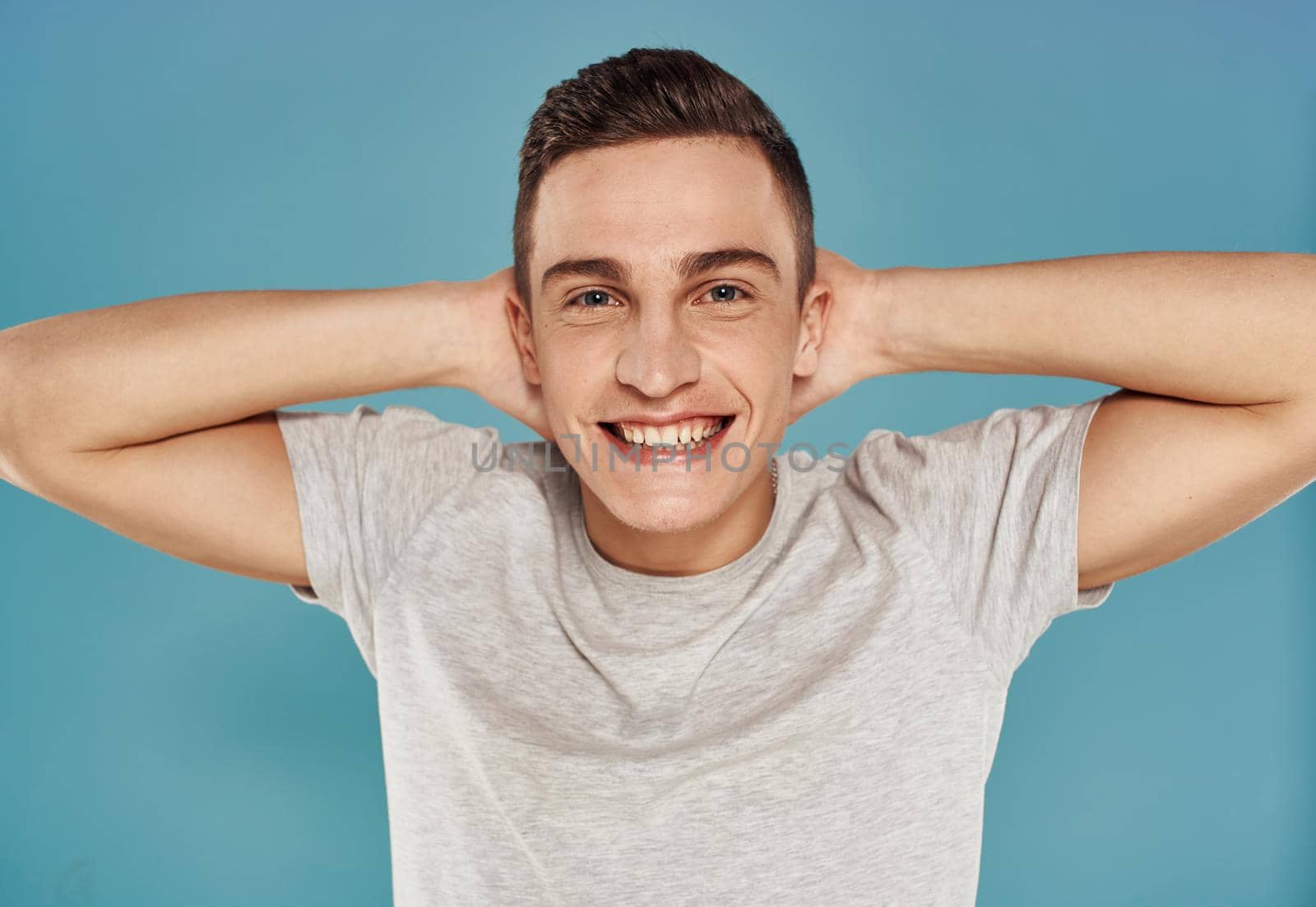 Cute man white t-shirt emotions cropped view blue background. High quality photo