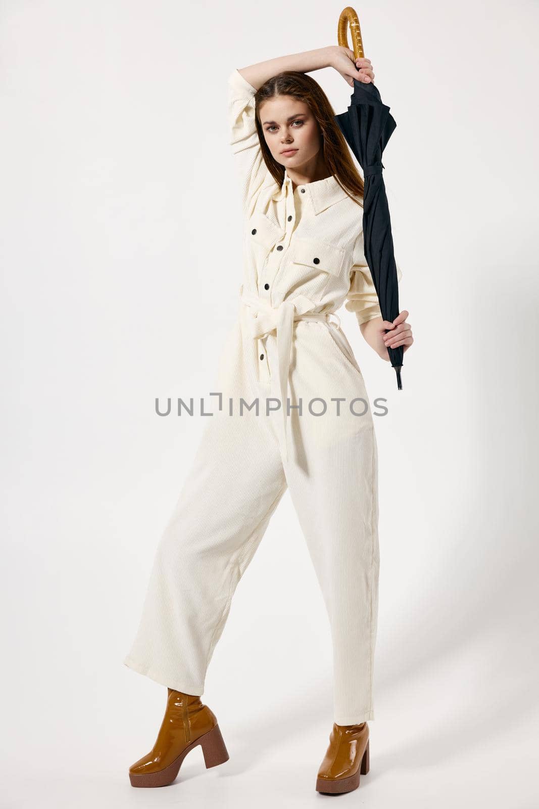 pretty woman in suit umbrella in hands protection from rain modern style. High quality photo