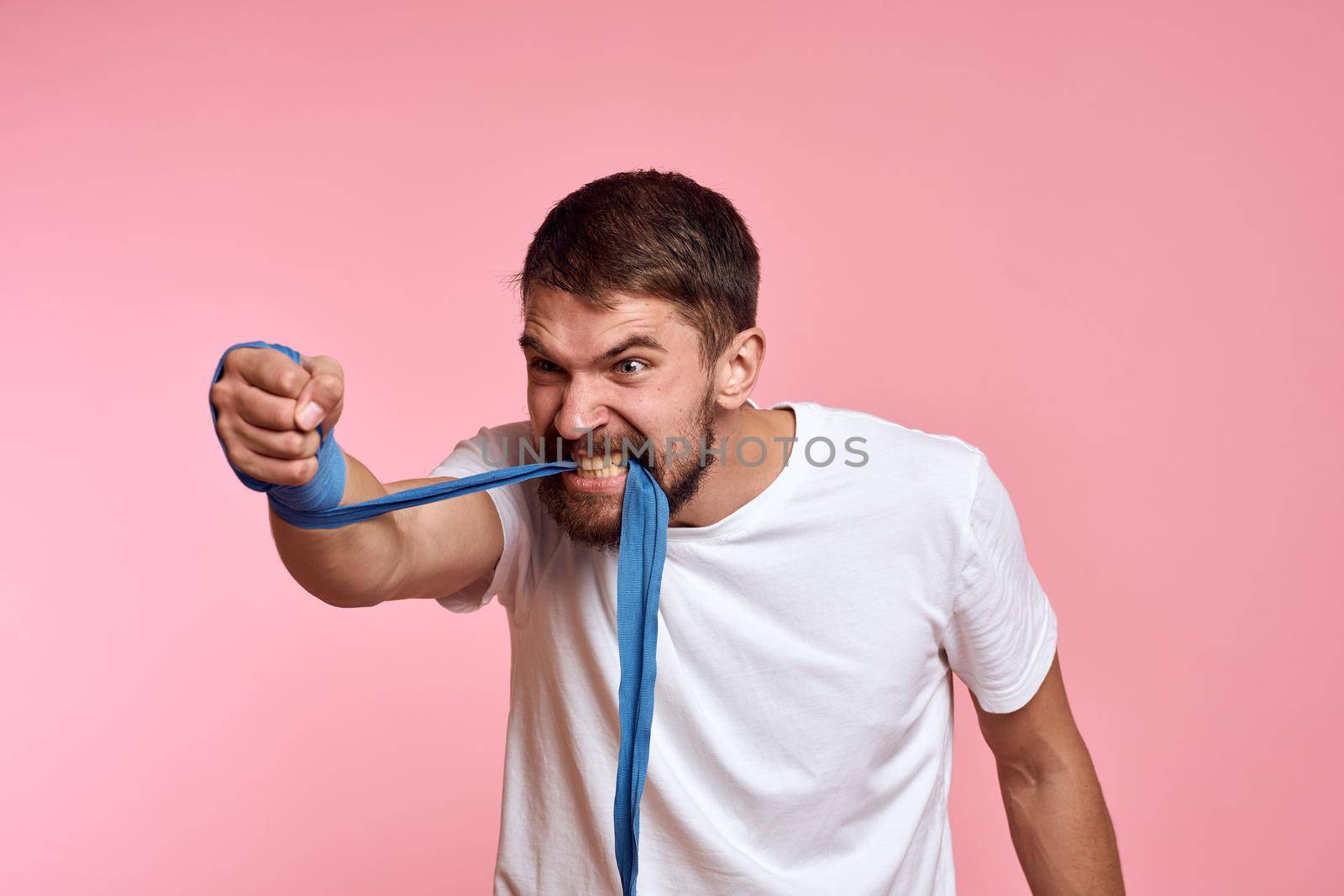 sports man boxing bandage pink workout background. High quality photo