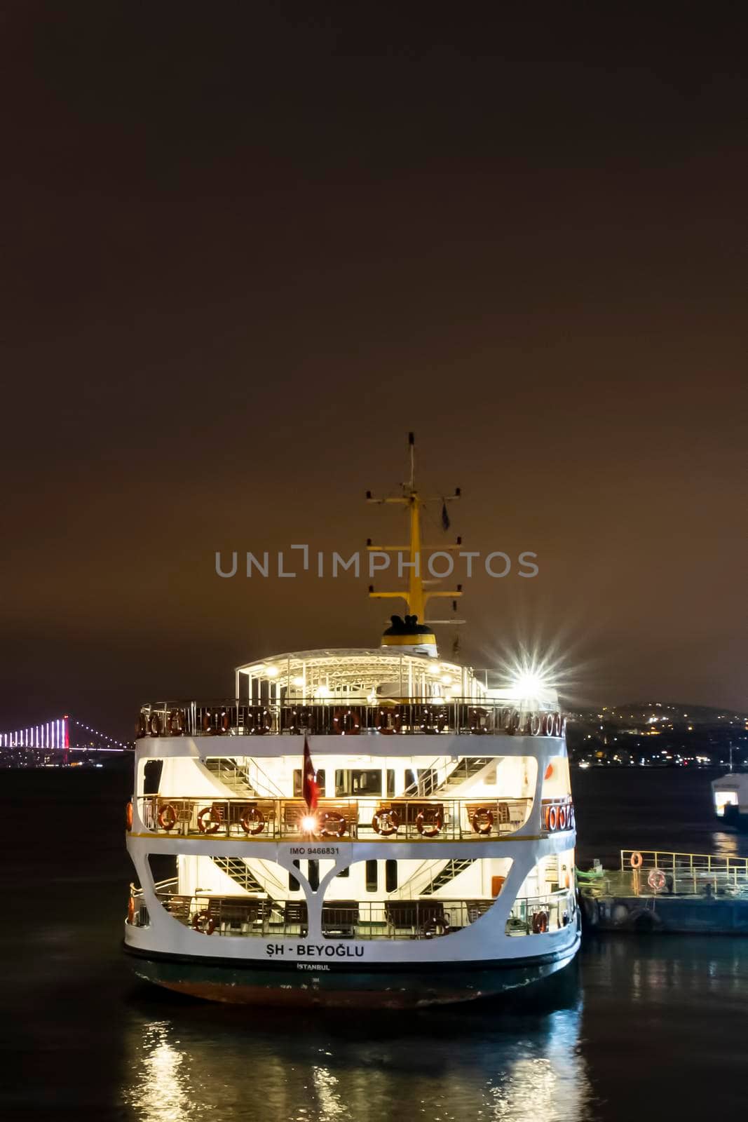 city lines ferry at eminonu pier at dusk in the morning in istanbul city. by yilmazsavaskandag