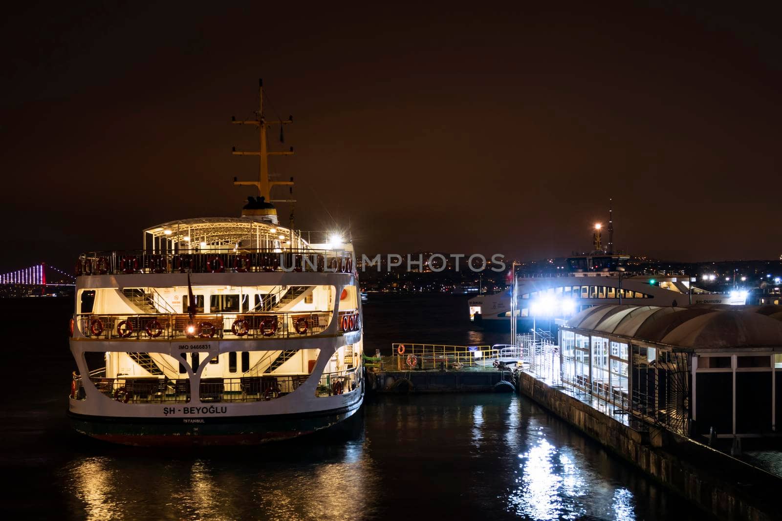 eminonu,istanbul,turkey-february 19,2021.city lines ferry at eminonu pier at dusk in the morning in istanbul city.