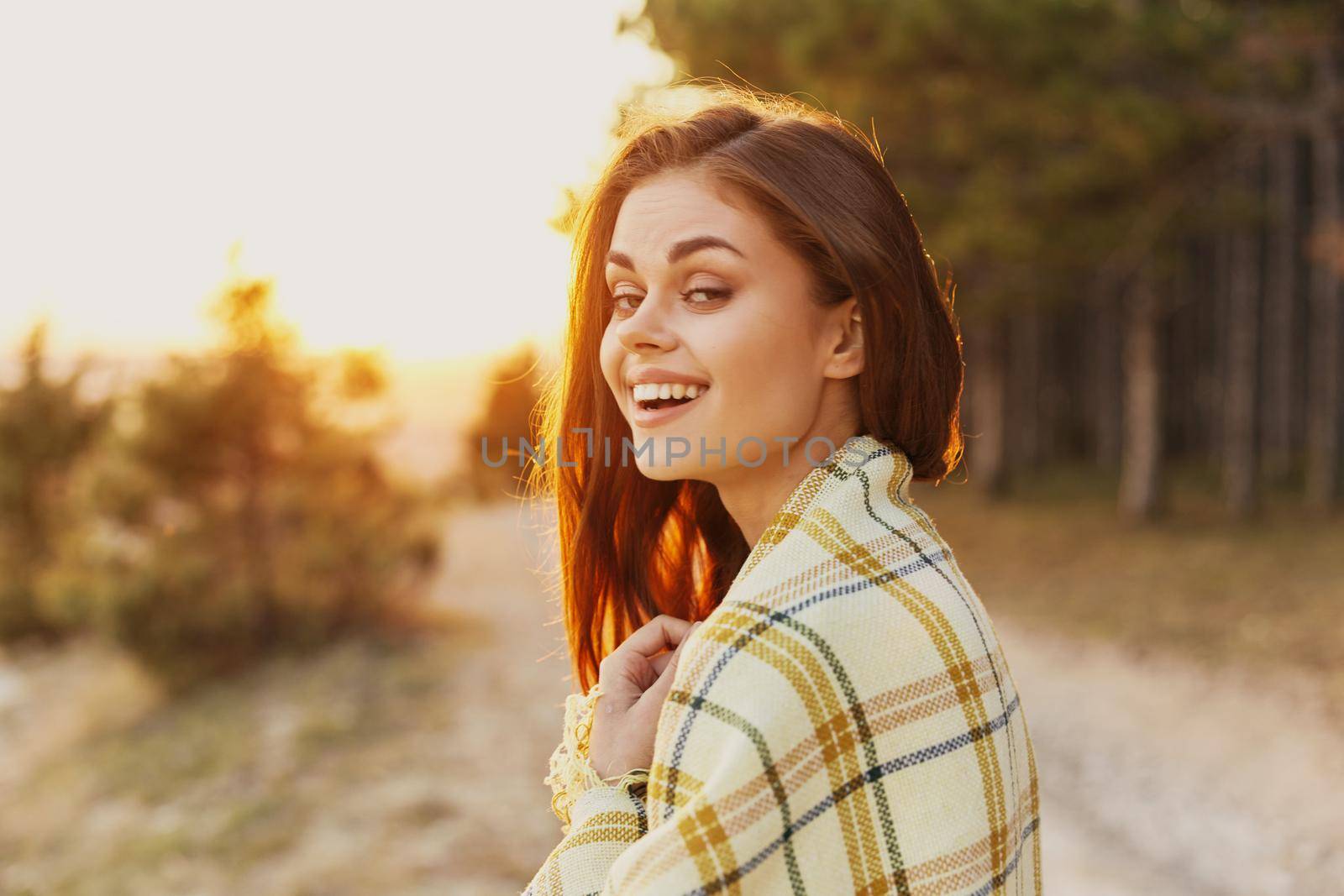 happy woman near coniferous forest road plaid sunset by SHOTPRIME