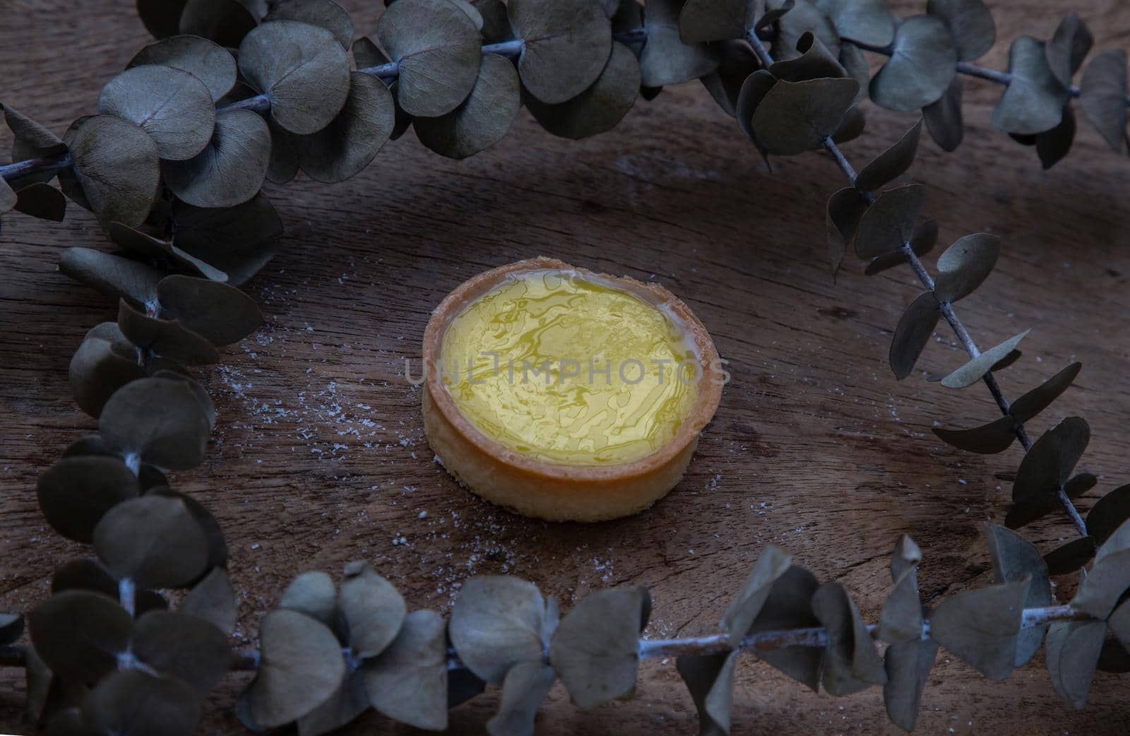 Lemon tart and Dried flowers on old rustic wooden table. Bakery and dessert concept, Selective focus.