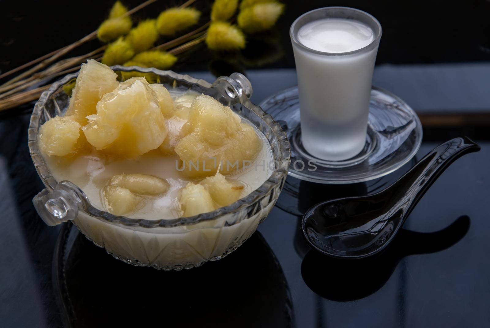 Cassava in syrup usually served with coconut milk on black table. Traditional desserts in Thailand. Selective focus.