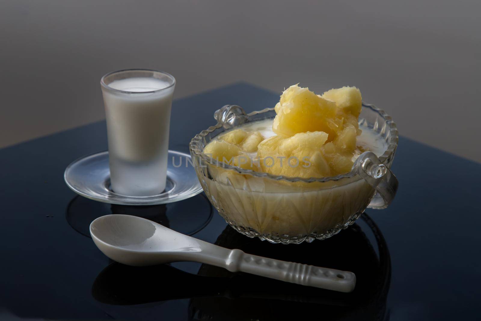 Cassava in syrup usually served with coconut milk on black table. Traditional desserts in Thailand. Selective focus.