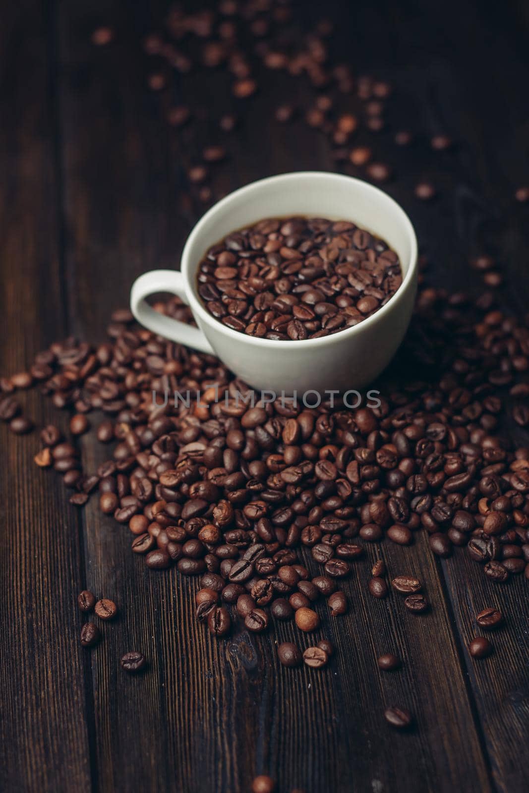 cup with coffee grains on a wooden table aromatic drink Arabica product by SHOTPRIME