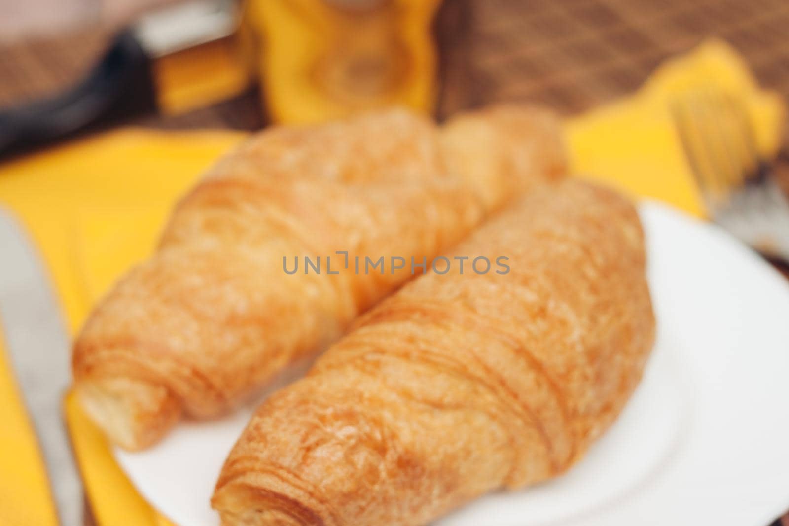 croissants in a plate on the table meal dessert for breakfast a cup of coffee. High quality photo