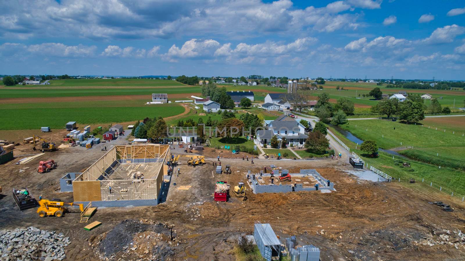 Aerial View of an Amish Barn Raising after a large fire destroyed them on a beautiful summer day