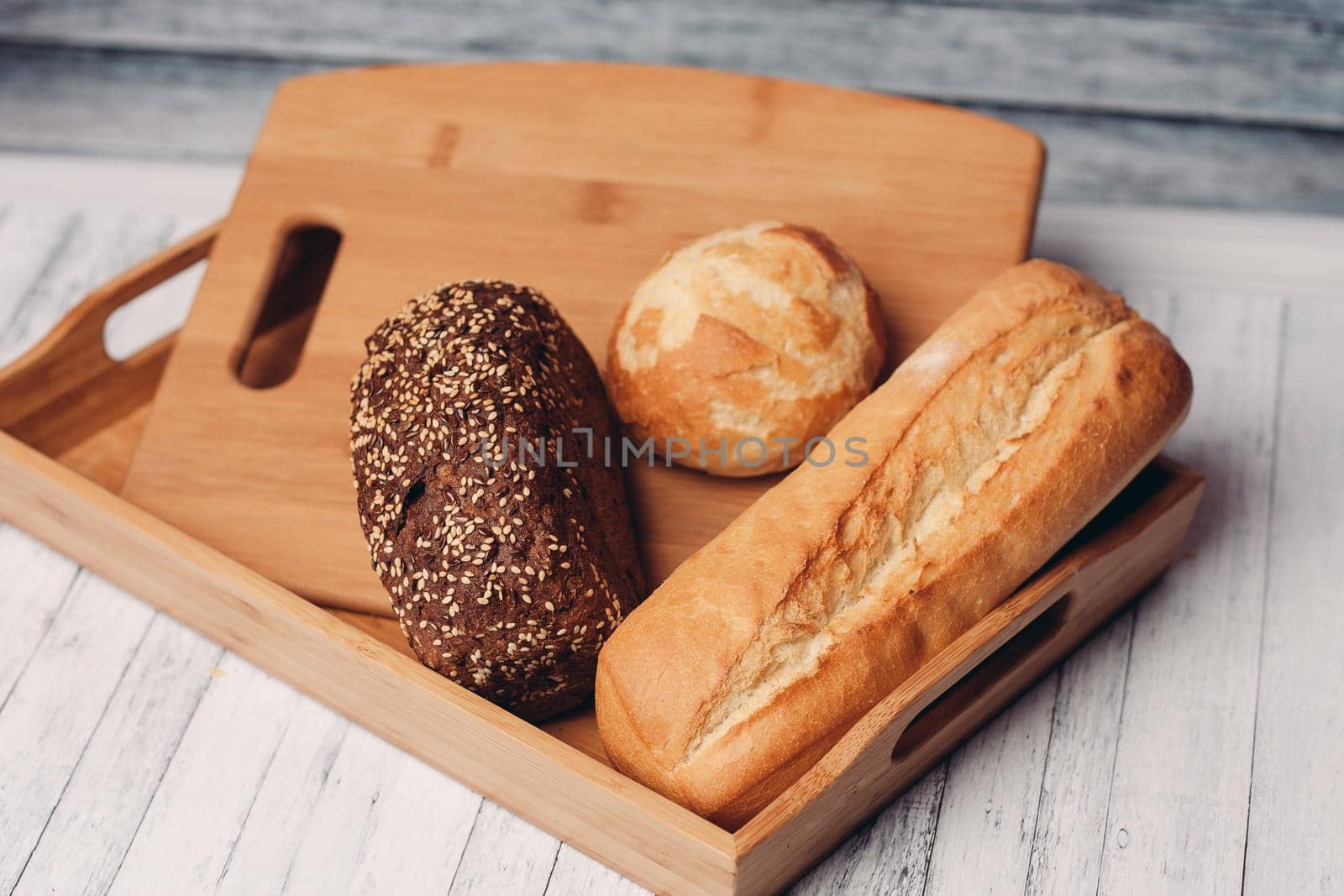 whole grain bread loaves homemade cakes cooking wood board close-up. High quality photo