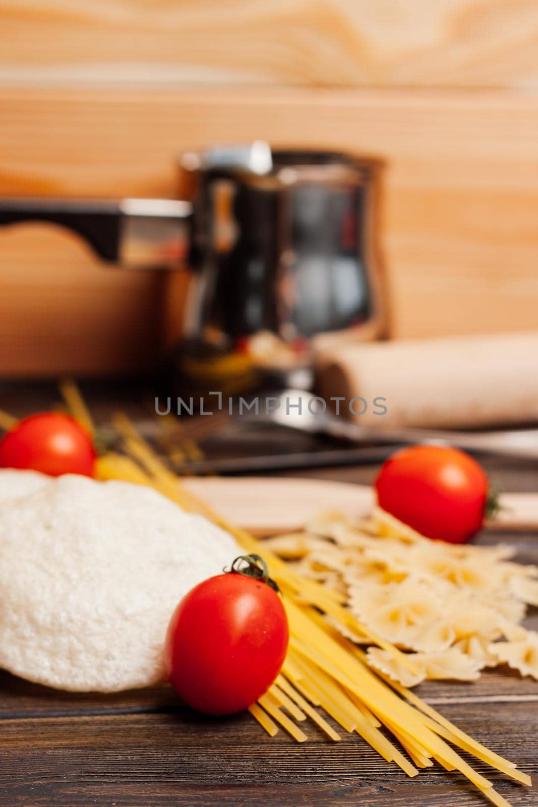 cherry tomatoes pasta kitchenware wooden table italian cuisine. High quality photo