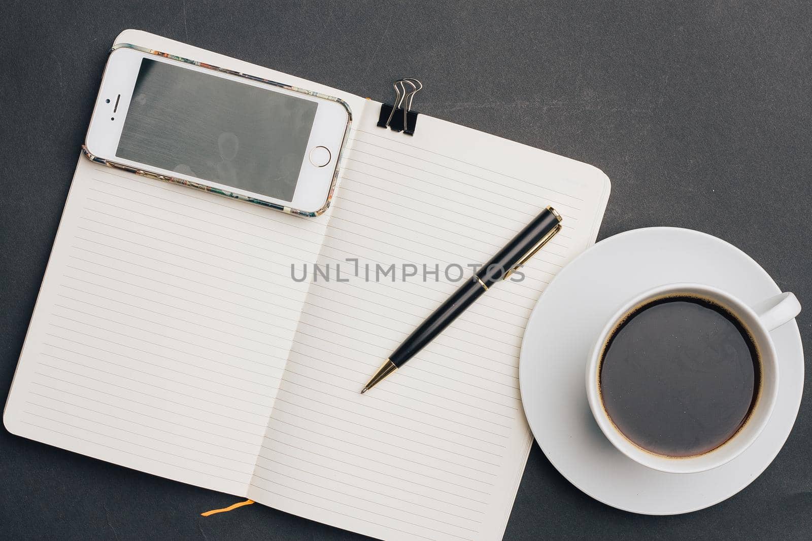 notebook on the table coffee cup pen office work business. High quality photo