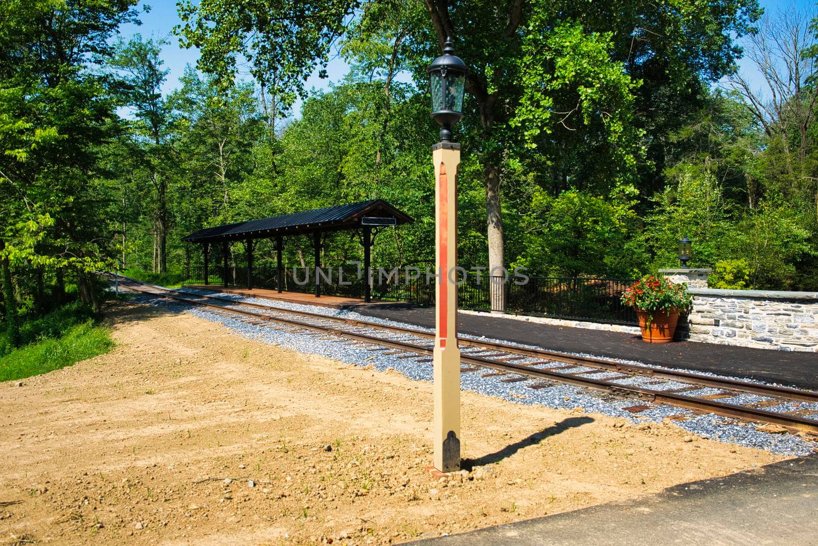 A Small Train Station Waiting for Passengers and a Train