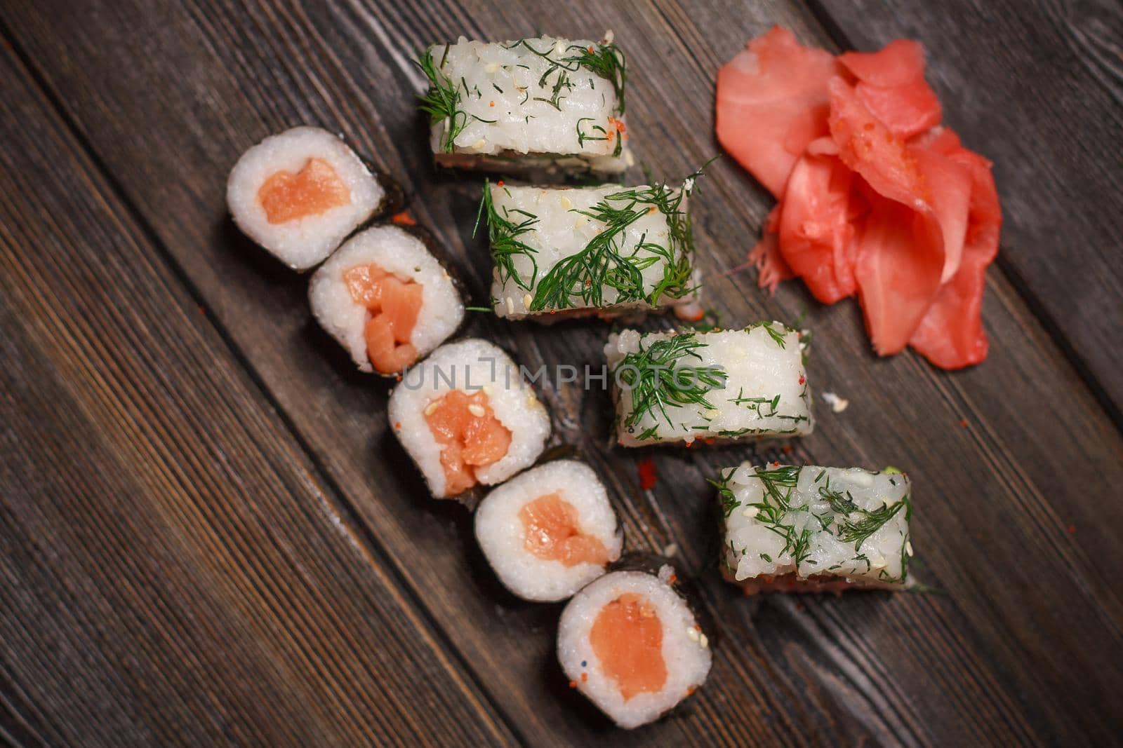 ginger seafood wooden table sushi and rolls delicacy. High quality photo