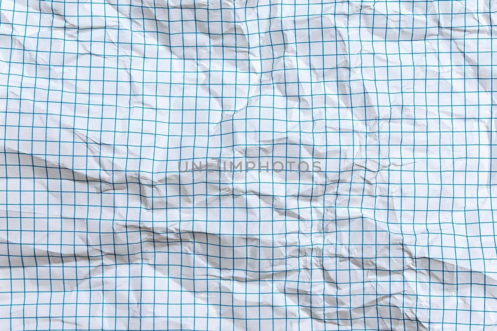 Background, texture of a crumpled notebook sheet with grid-like markings