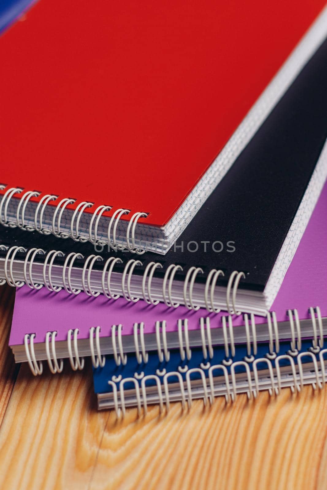 colorful notepads office wooden table paper work is education by SHOTPRIME
