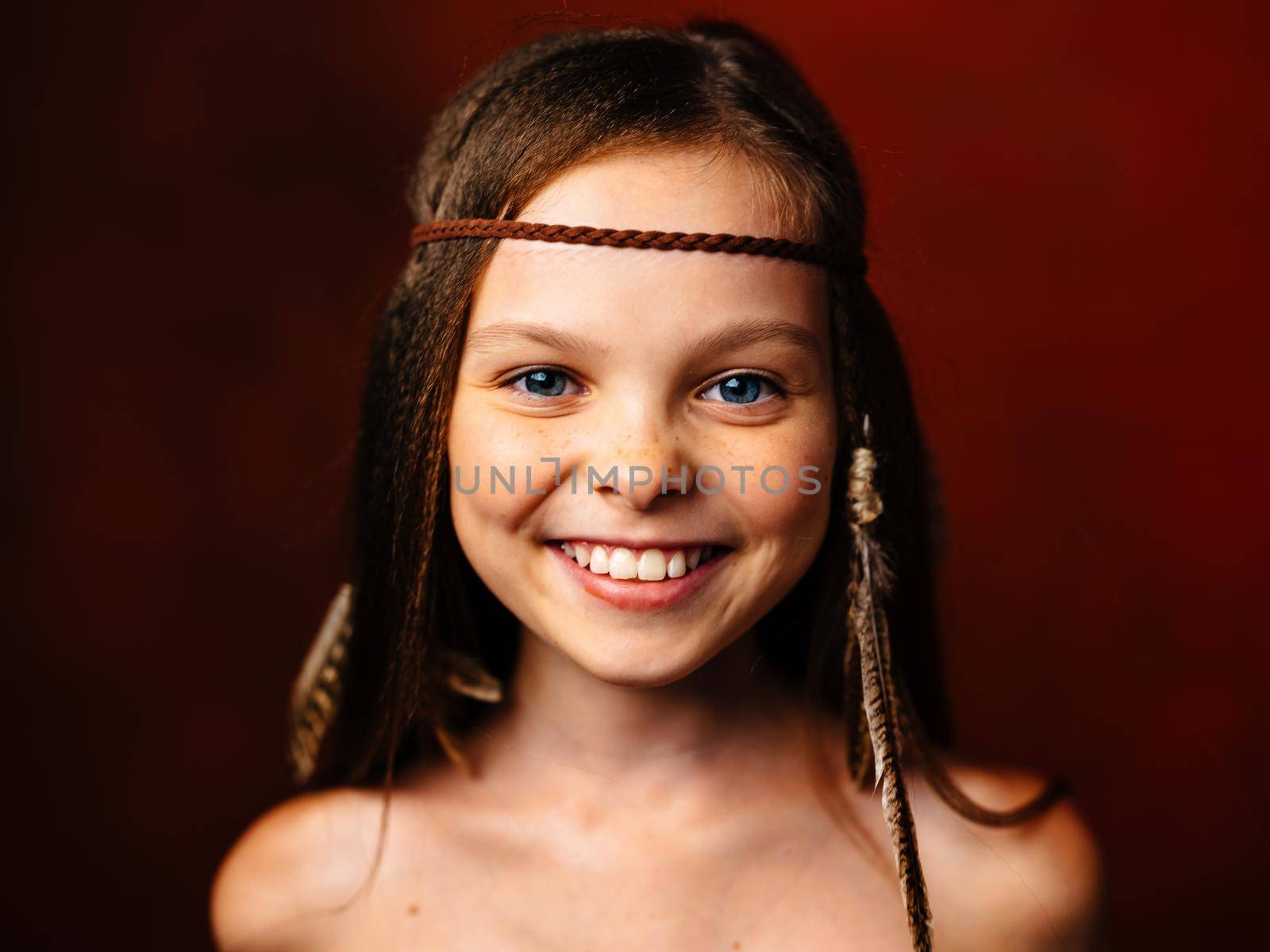 wild girl with feather in her hair smile loose hair indian culture. High quality photo