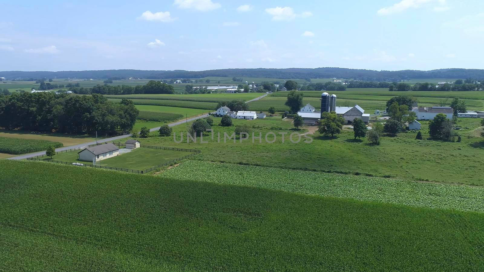 Aerial View of an Amish One Room School House in the Middle Of Amish Farmlands on a Sunny Day